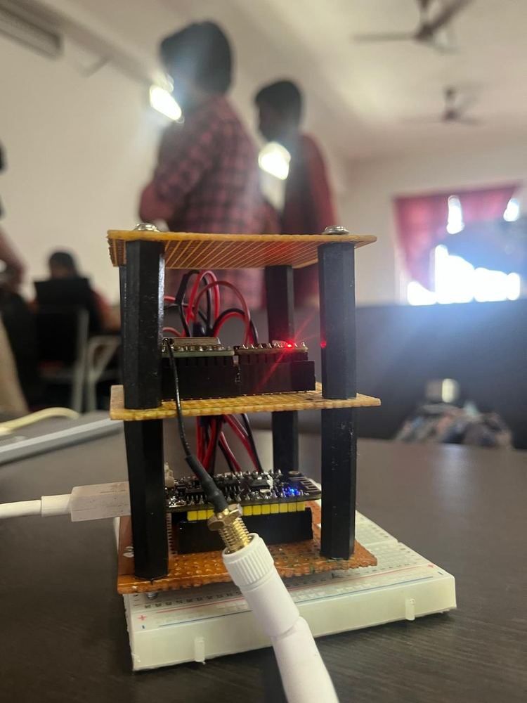 Team DhruvTaara — 15-member CanSat team at SEDS VIT Chennai with the assembled hardware and ground station laptop visible in foreground